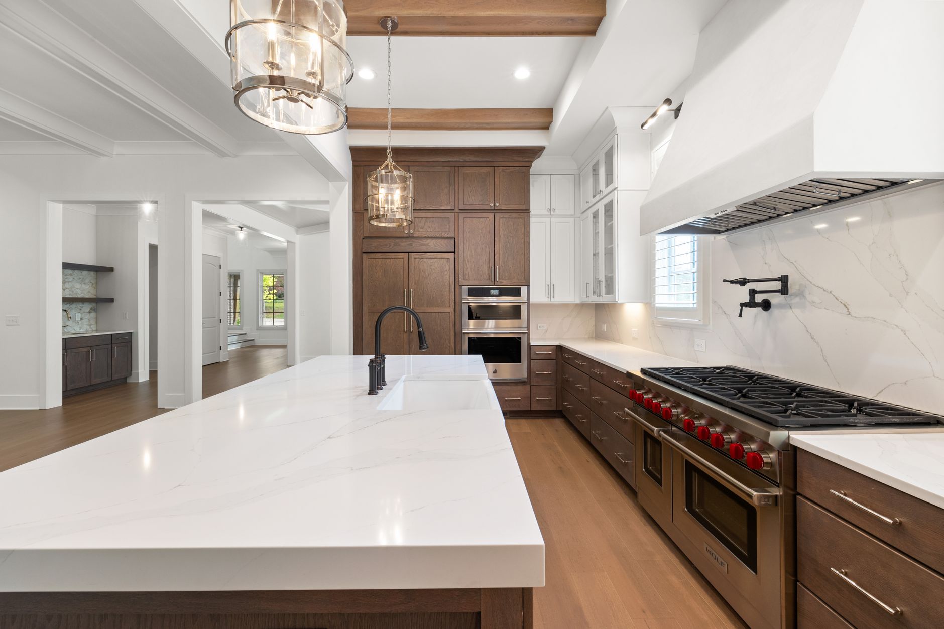 Elegant modern kitchen featuring marble countertops, stainless steel appliances, and hardwood floors in Austin, TX